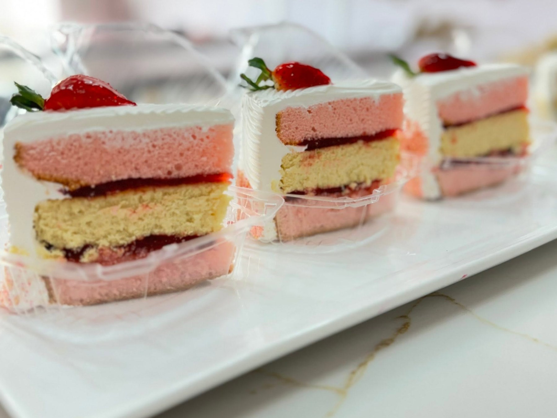 Strawberry cake slices showing layers